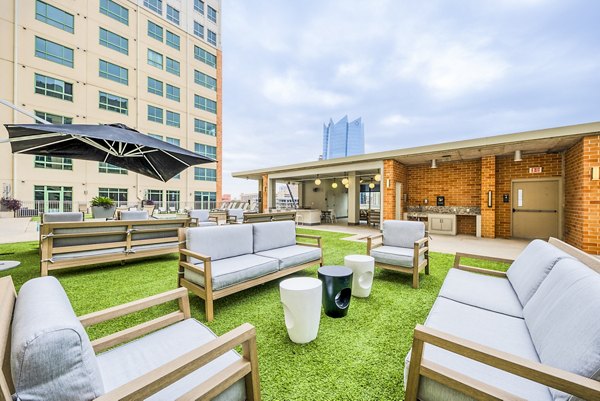 Spacious patio with city views at Inspire Downtown Apartments, perfect for relaxation and outdoor dining in a luxury urban setting