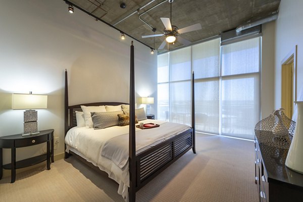 Spacious bedroom with modern decor at The Museum Tower Apartments, luxury living in a vibrant cityscape