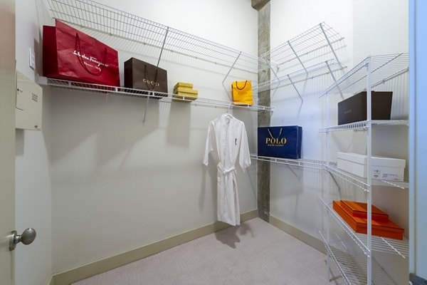 Walk-in closet with built-in shelving at The Museum Tower Apartments