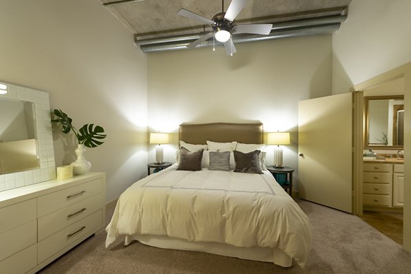 Modern bedroom with sleek decor at The Museum Tower Apartments with large windows and elegant furnishings