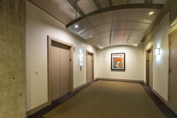 Modern hallway featuring contemporary art displays at The Museum Tower Apartments in luxury residential complex