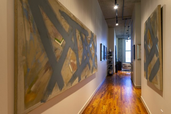 Hallway featuring modern art and contemporary lighting at The Museum Tower Apartments, offering luxurious living in a prime location