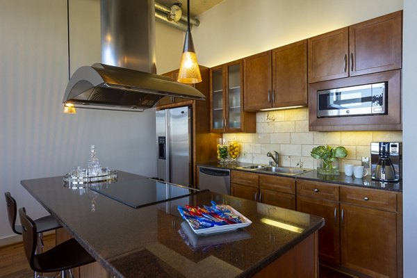 Modern kitchen with sleek cabinetry and stainless steel appliances at The Museum Tower Apartments