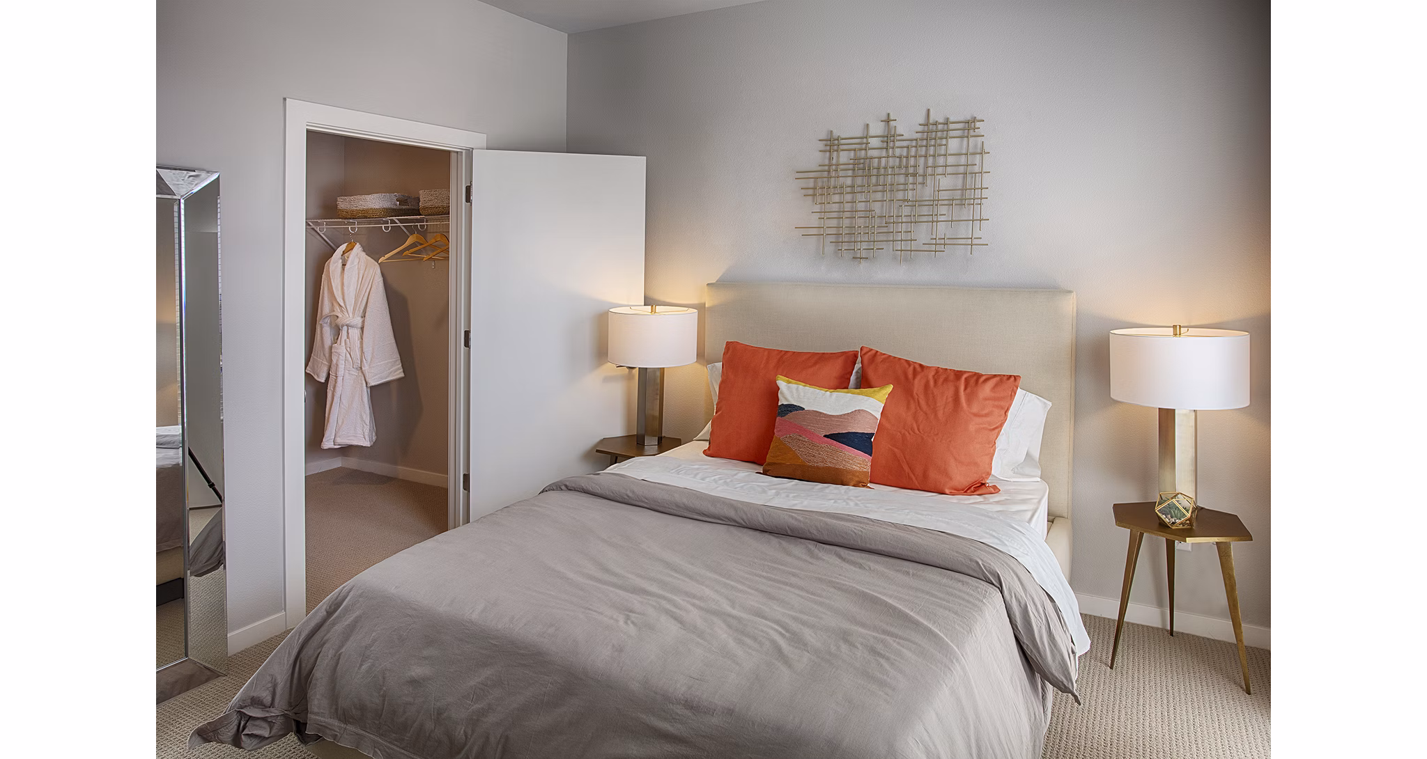 Cozy queen-size bed and modern decor in a bedroom at South Main Station Apartments