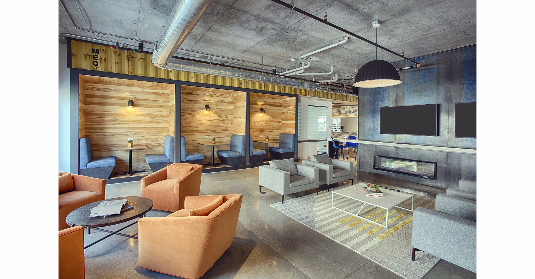 Modern clubhouse with cozy seating and game area at South Main Station Apartments, a luxury living community