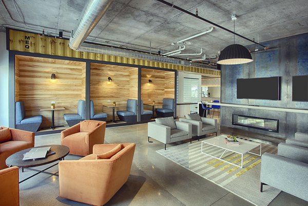 Modern clubhouse with cozy seating and game area at South Main Station Apartments, a luxury living community
