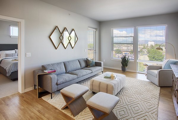 Spacious living room with contemporary furnishings at South Main Station Apartments, offering luxury living near downtown amenities
