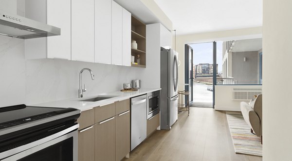 Modern kitchen with stainless steel appliances in Hamilton Cove Apartments