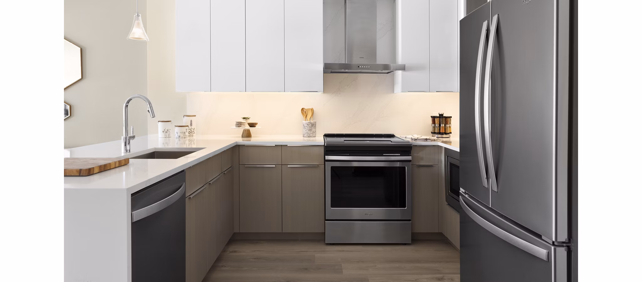 Modern kitchen featuring stainless steel appliances and granite countertops in Hamilton Cove Apartments