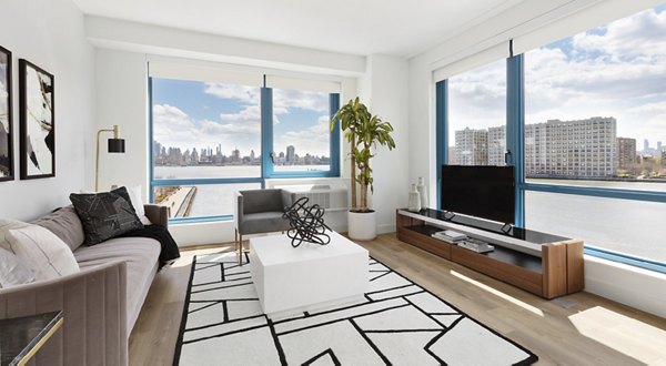 Cozy living room with contemporary furniture and large windows in Hamilton Cove Apartments