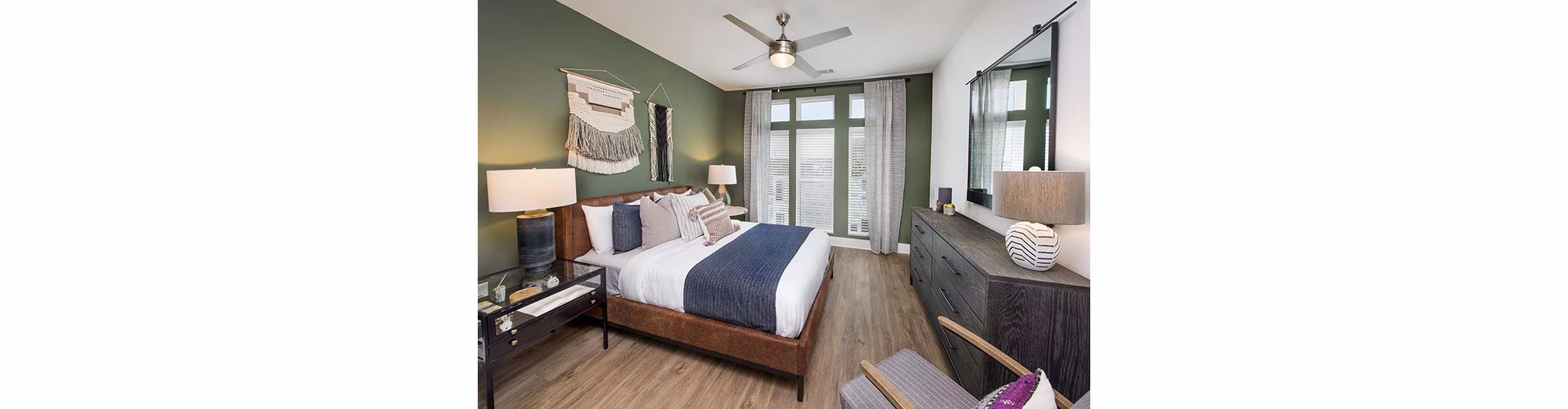 Cozy bedroom with modern decor at The Penrose Apartments