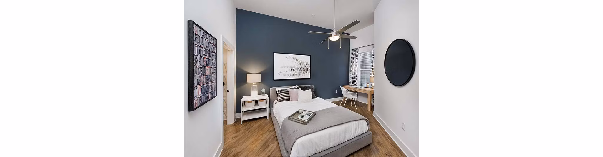 Elegant bedroom with modern decor at The Penrose Apartments featuring luxury finishes and ample natural light