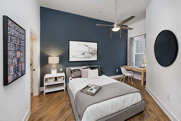 Elegant bedroom with modern decor at The Penrose Apartments featuring luxury finishes and ample natural light