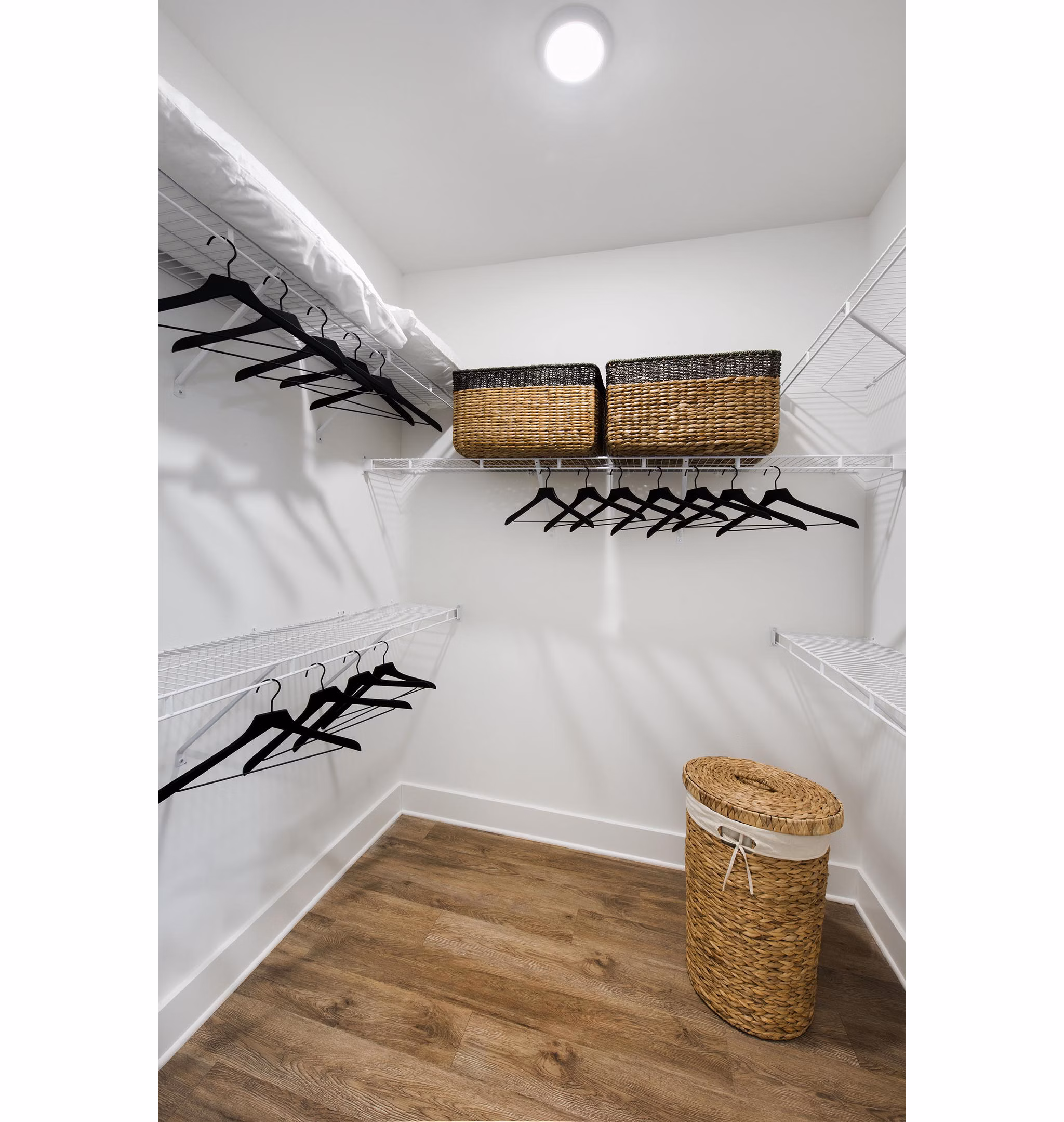Walk-in closet with ample storage space at The Penrose Apartments, luxury living in a stylish Greystar community