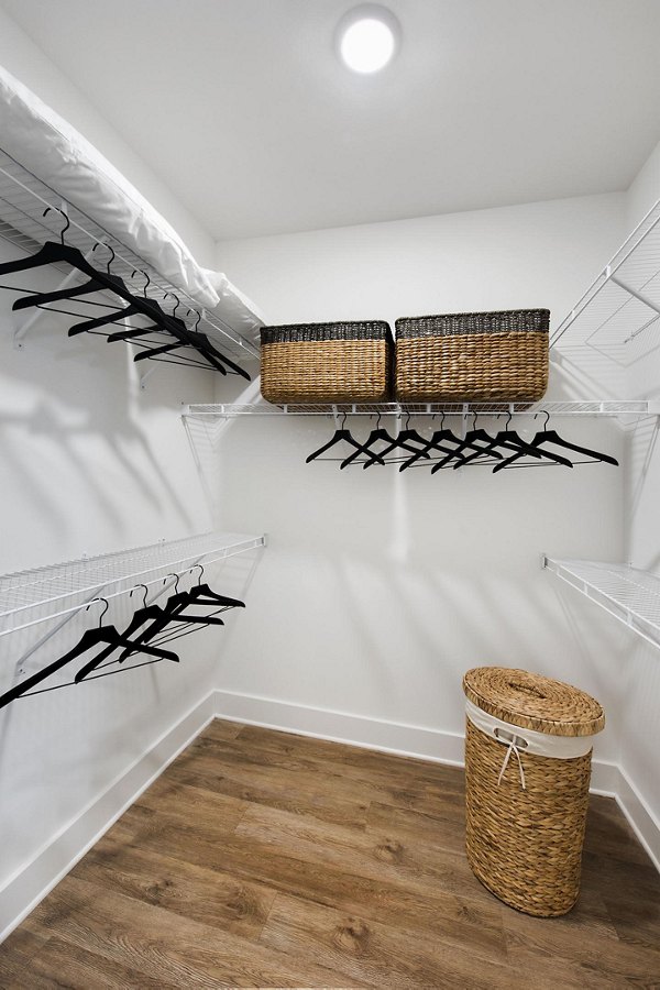 Walk-in closet with ample storage space at The Penrose Apartments, luxury living in a stylish Greystar community