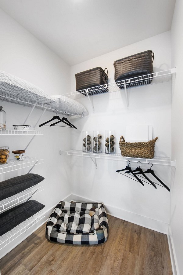 Walk-in closet with custom shelving in The Penrose Apartments