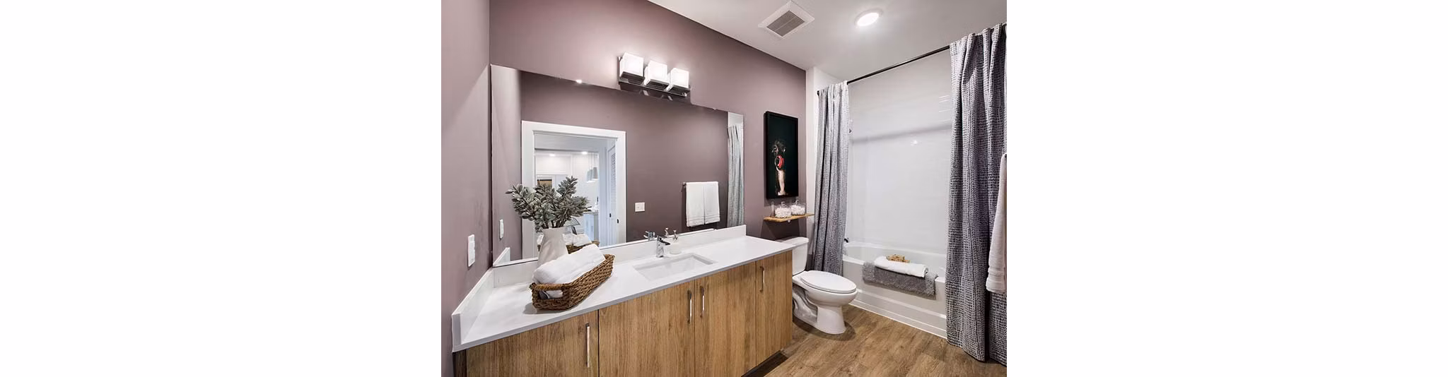 Modern bathroom with sleek fixtures and spacious design at The Penrose Apartments