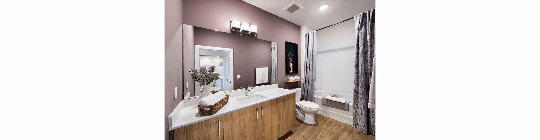 Modern bathroom with sleek fixtures and spacious design at The Penrose Apartments