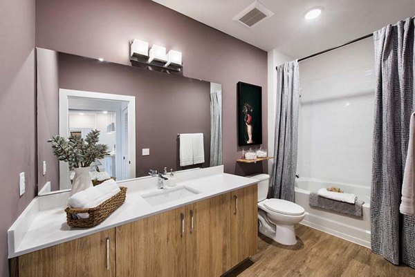 Modern bathroom with sleek fixtures and spacious design at The Penrose Apartments