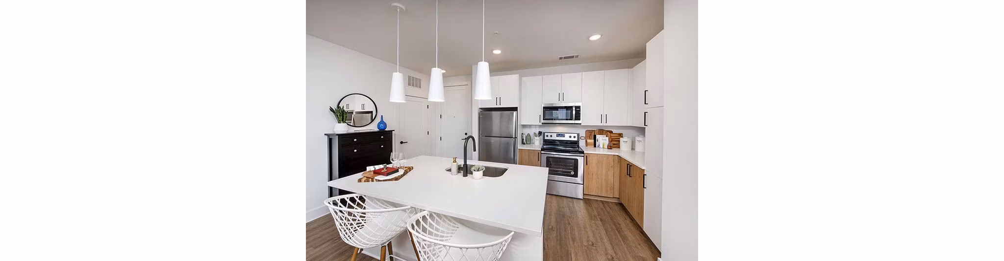 Modern kitchen with stainless steel appliances and sleek countertops at The Penrose Apartments, luxury living in a stylish setting