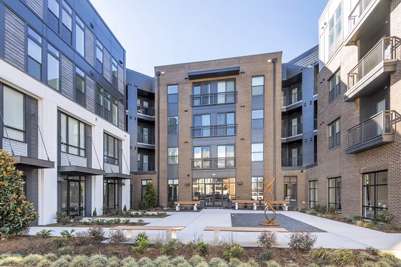 Courtyard with lush gardens at The Penrose Apartments featuring luxury living spaces for residents