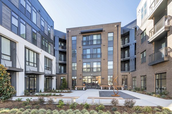 Courtyard with lush gardens at The Penrose Apartments featuring luxury living spaces for residents