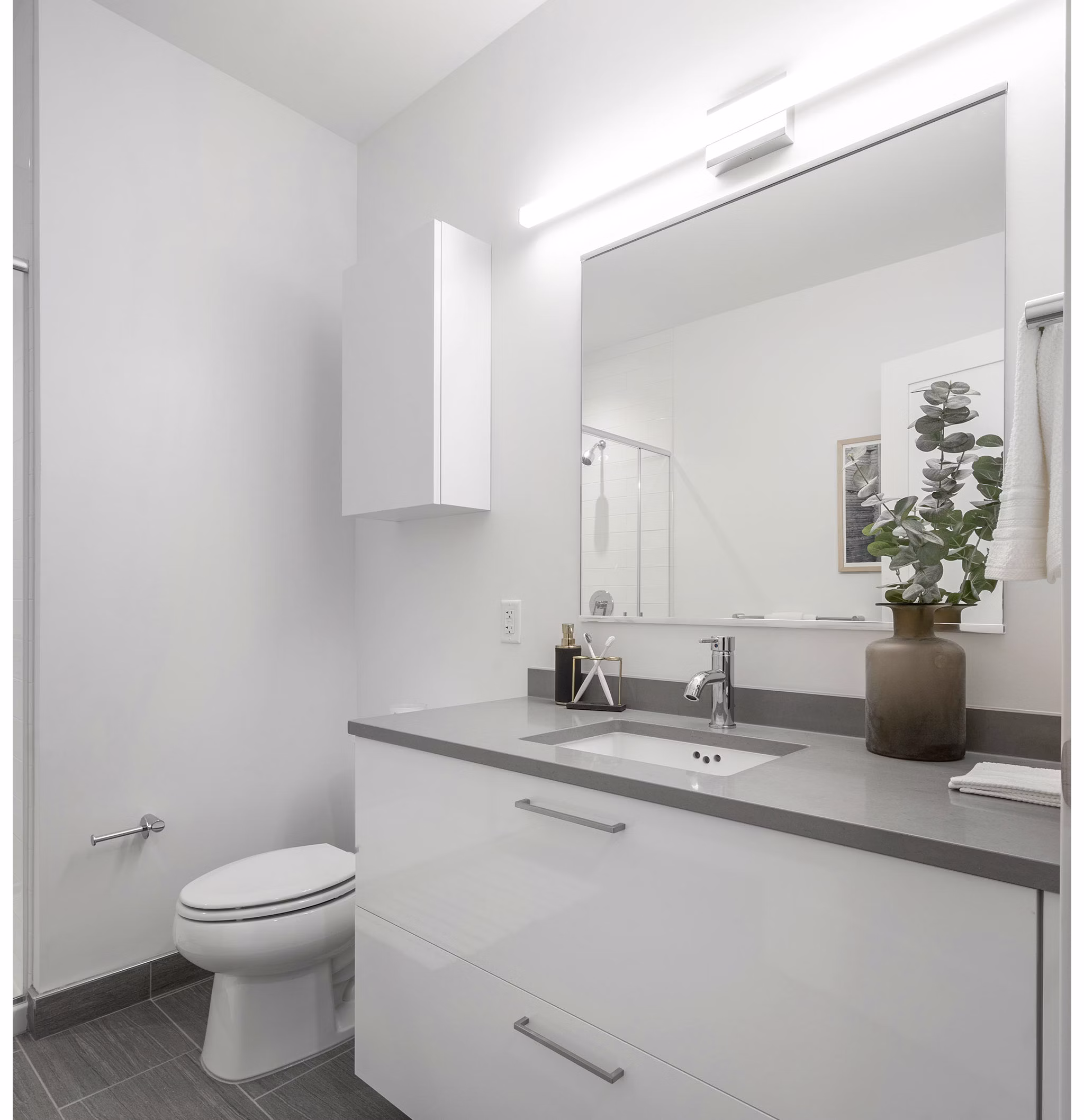 Elegant bathroom featuring marble countertops and modern fixtures at The Smith Apartments