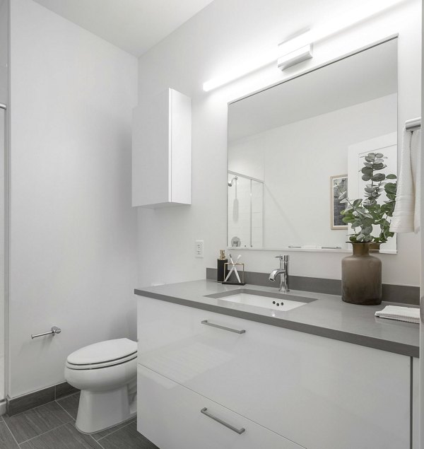 Elegant bathroom featuring marble countertops and modern fixtures at The Smith Apartments