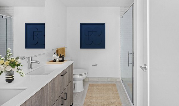 Elegant bathroom with marble countertops and modern fixtures at The Smith Apartments luxury living