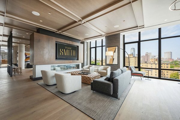 Modern clubhouse with plush seating and meeting spaces at The Smith Apartments, ideal for socializing and relaxation with community members