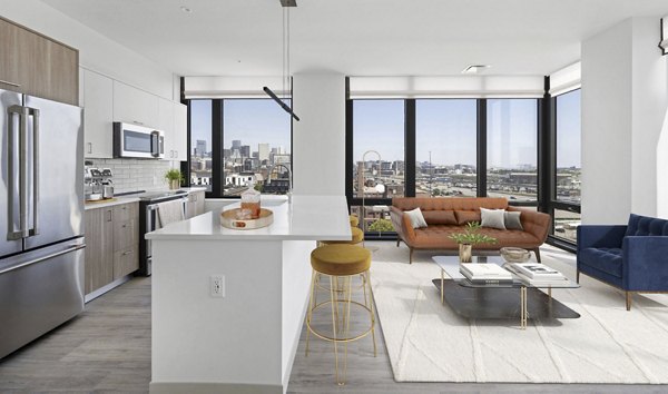Contemporary living room with stylish decor and large windows in The Smith Apartments