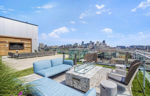 Cozy fire pit on elegant patio at The Smith Apartments balcony, perfect for luxury outdoor living