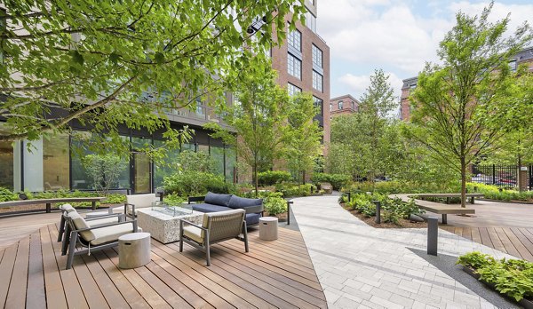 Fire pit in cozy courtyard at The Smith Apartments: Luxury retreat in a Greystar community