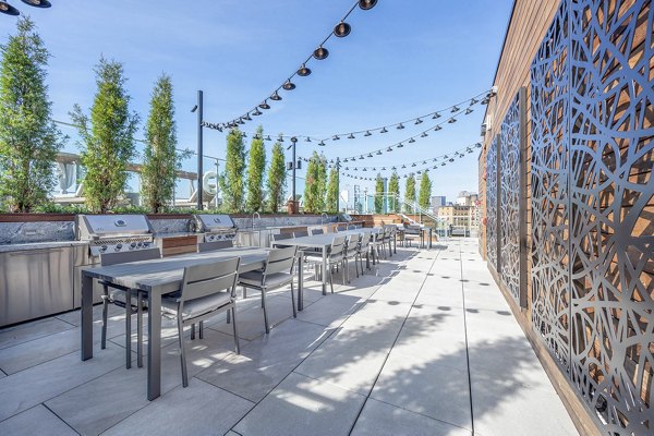 Outdoor grill area with modern patio furnishings at The Smith Apartments, perfect for entertaining and relaxation