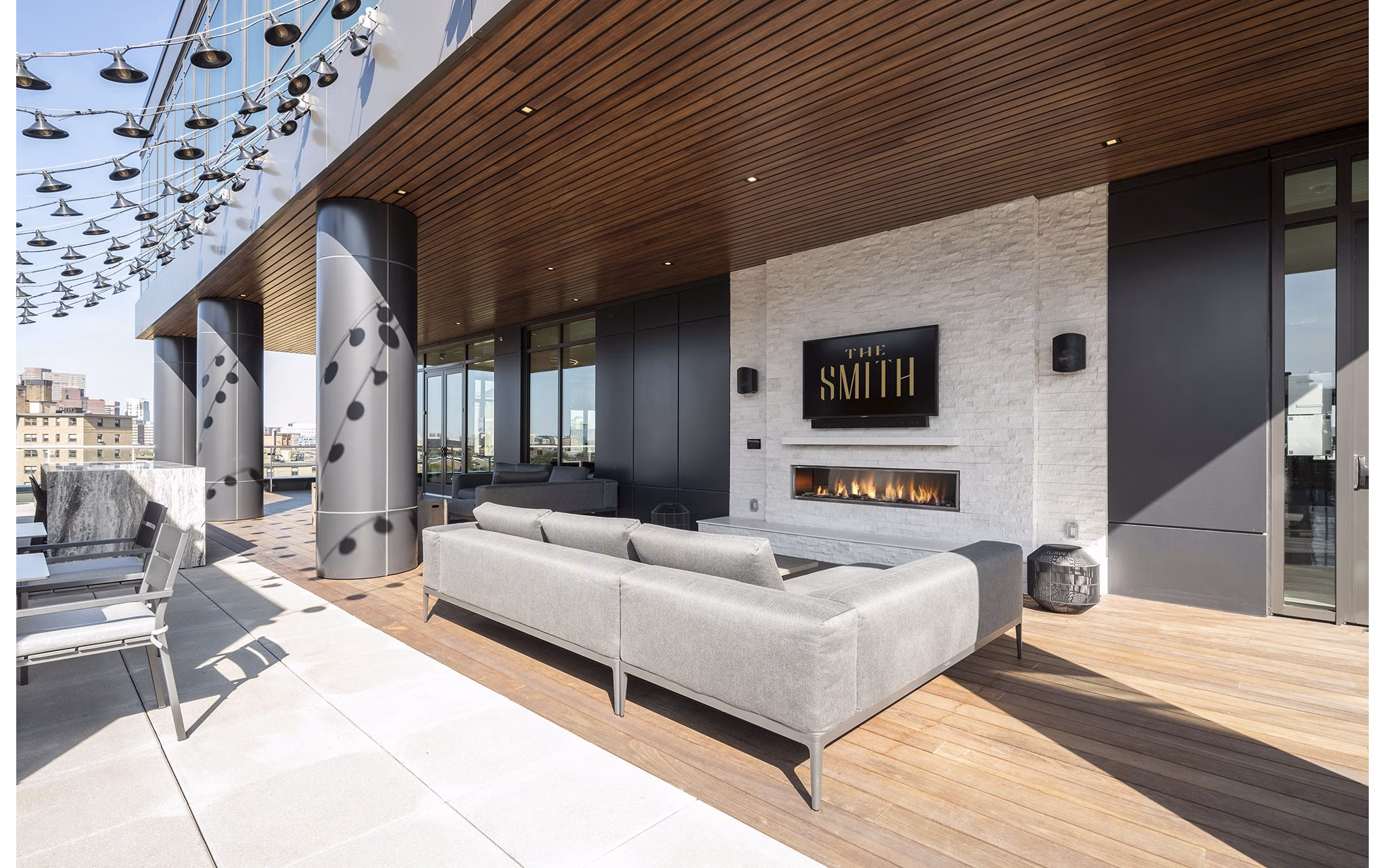Cozy fire pit and stylish patio at The Smith Apartments, perfect for outdoor relaxation and entertaining