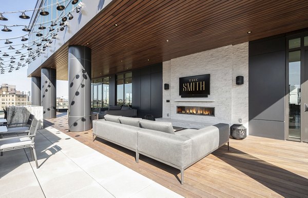 Cozy fire pit and stylish patio at The Smith Apartments, perfect for outdoor relaxation and entertaining