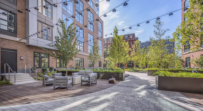 Charming patio with cozy seating in the courtyard at The Smith Apartments, ideal for outdoor relaxation and social gatherings