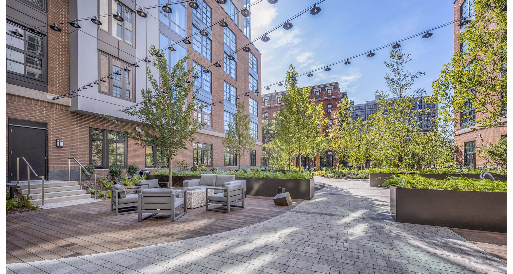 Charming patio with cozy seating in the courtyard at The Smith Apartments, ideal for outdoor relaxation and social gatherings