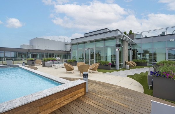 Stunning outdoor pool with lounge chairs at The Smith Apartments, providing a luxury relaxation spot for residents