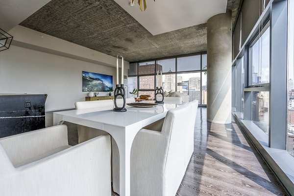Dining room featuring modern furnishings and ambient lighting in Imprint Apartments