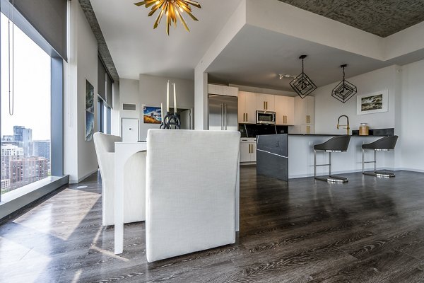 Dining area with contemporary furniture and pendant lighting in Imprint Apartments offering luxury living experience
