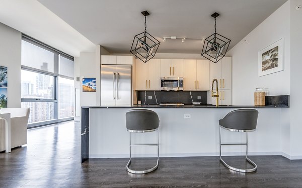 Modern kitchen with stainless steel appliances at Imprint Apartments offering luxury living in a vibrant community