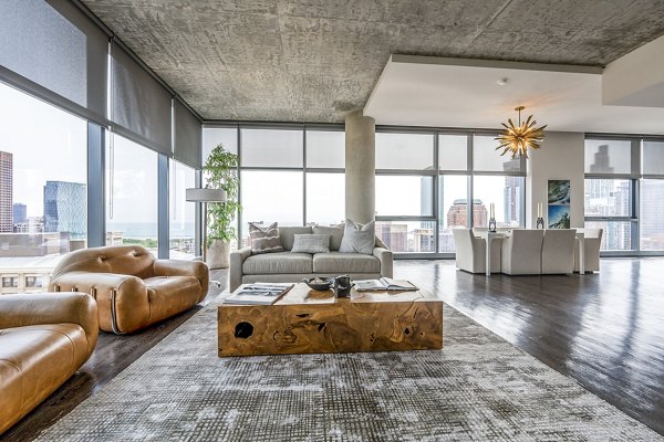 Contemporary living room with sleek furniture and natural light at Imprint Apartments, showcasing modern design and comfort