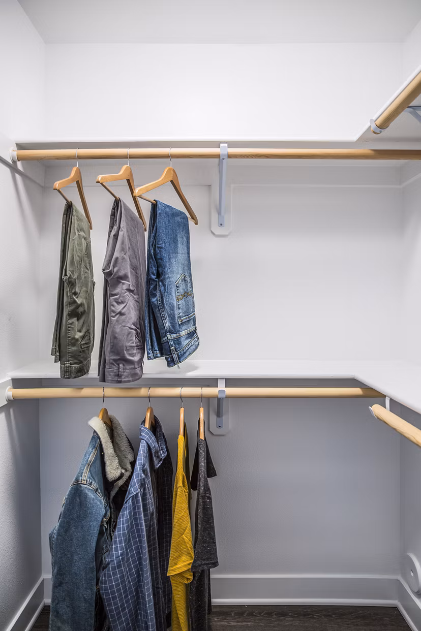 Walk-in closet with ample storage space at The Griffith Apartments, a luxury community in Los Angeles