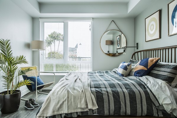 Cozy bedroom with stylish decor at The Griffith Apartments: Luxury living in city center