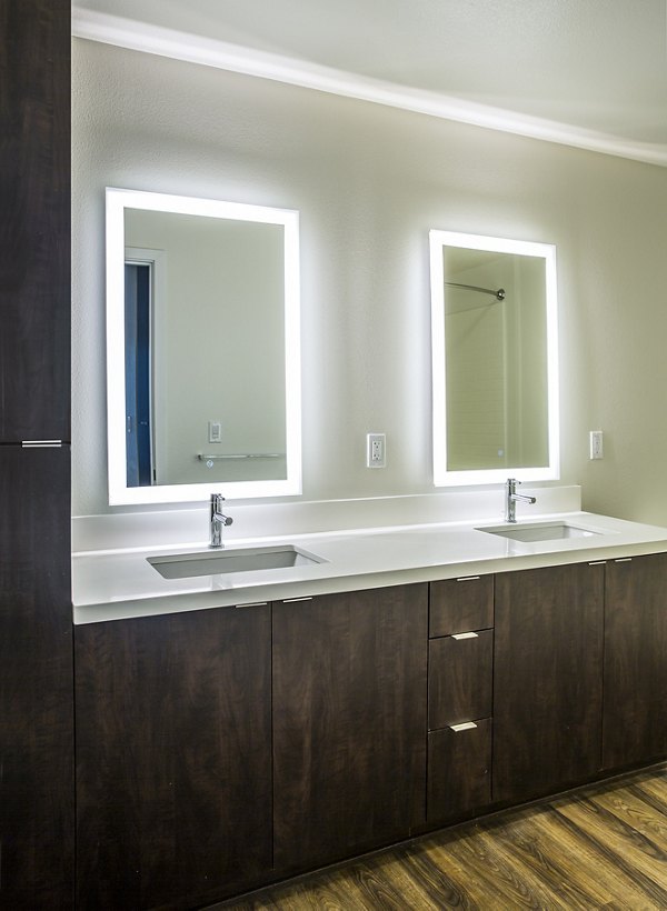 Bathroom with sleek fixtures and modern design at The Griffith Apartments, a luxury apartment community by Greystar