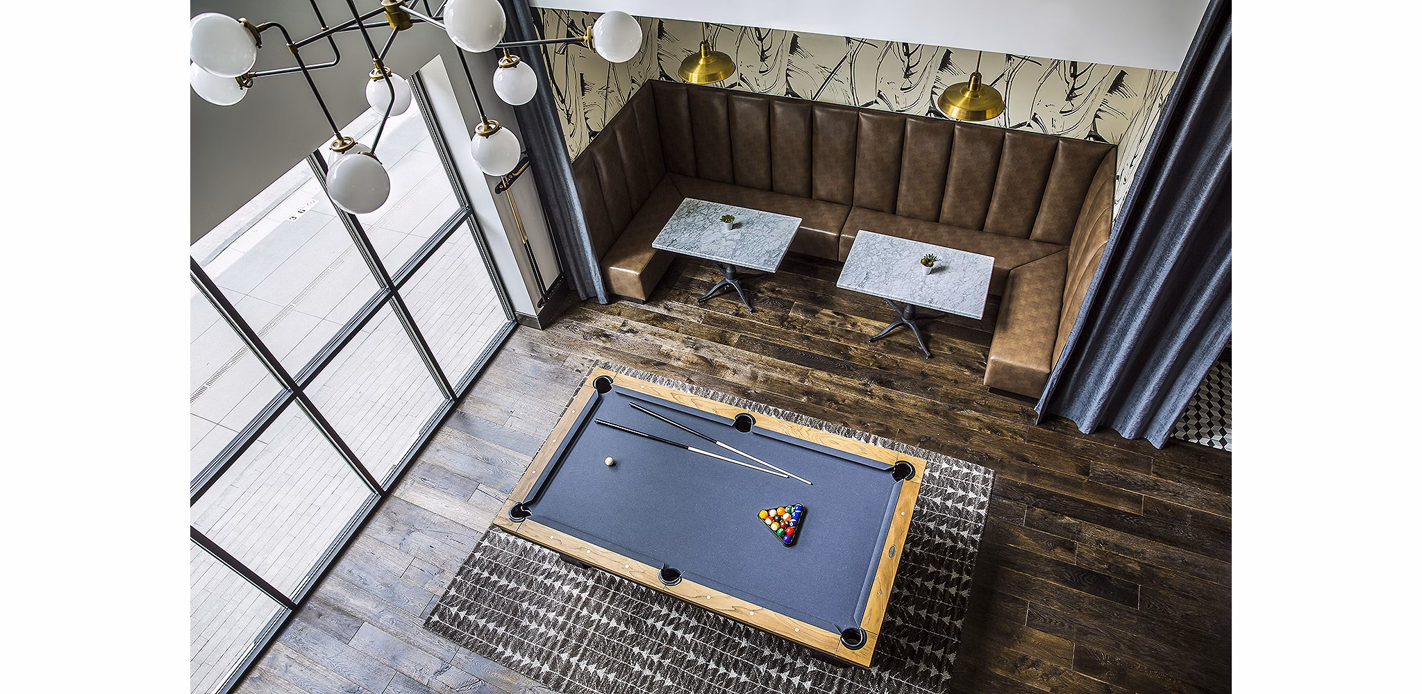 Game room featuring pool table and arcade games at The Griffith Apartments