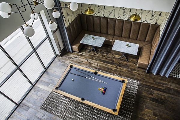 Game room featuring pool table and arcade games at The Griffith Apartments
