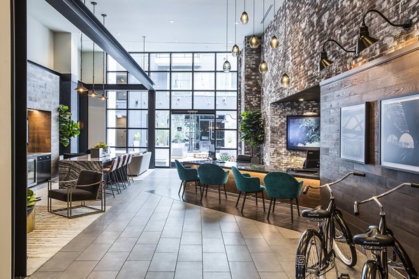The Griffith Apartments: Modern clubhouse with stylish seating and large windows in upscale neighborhood, perfect for socializing and events