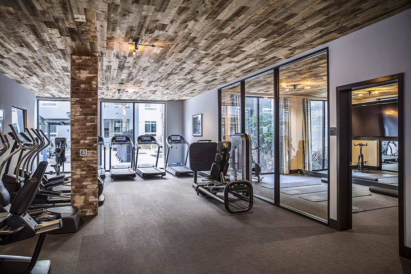 Modern fitness center with state-of-the-art gym equipment at The Griffith Apartments for luxury living in a stylish community